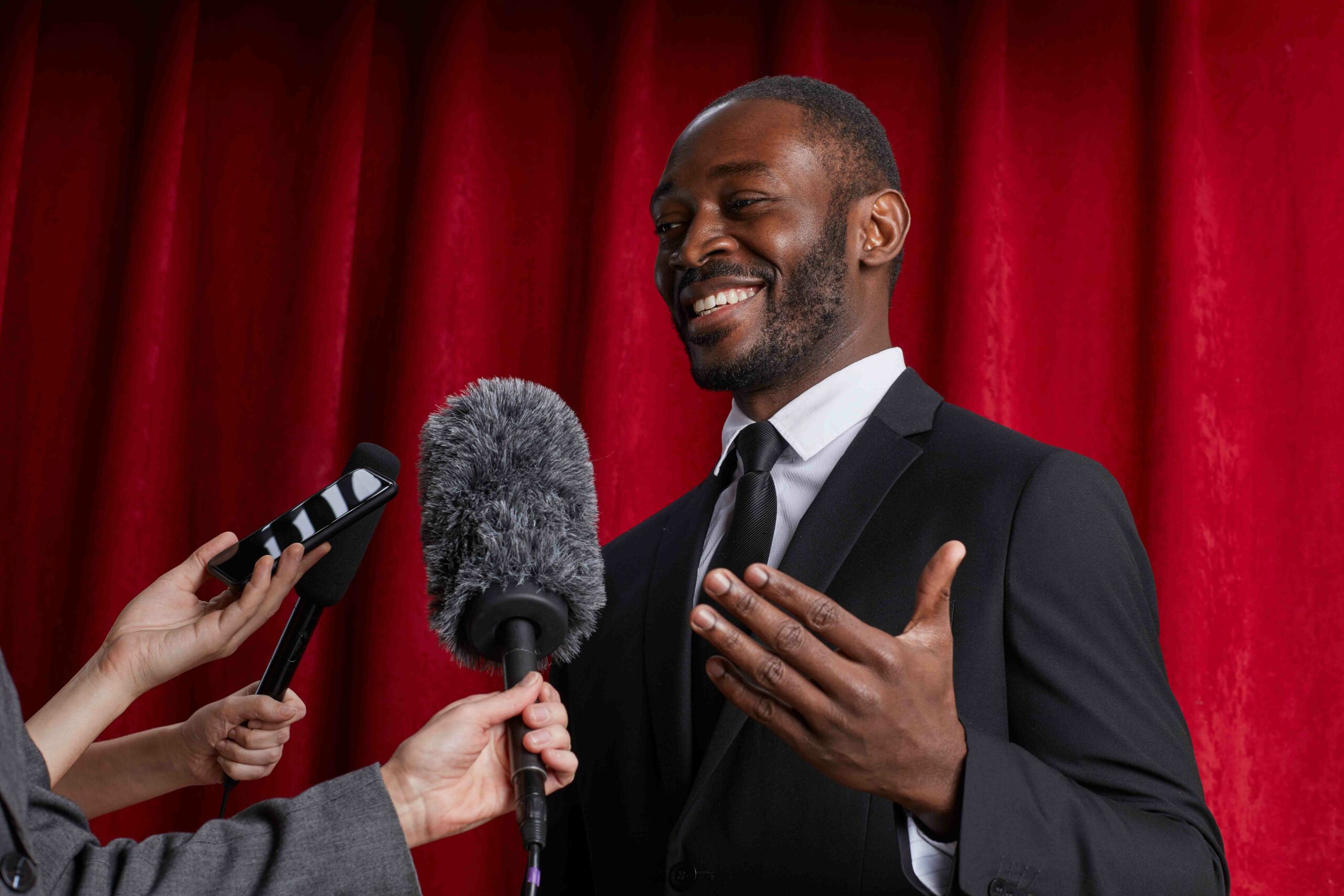 Black man speaking to the press